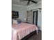 Comfortable bedroom featuring a stylish sliding barn door, ceiling fan, and decor at 85 Heather Point Ct # 850, New Smyrna Beach, FL 32169