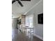 Dining area with white table and chairs, wood accent wall, and natural light at 85 Heather Point Ct # 850, New Smyrna Beach, FL 32169