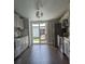 Modern kitchen with stainless steel appliances, grey cabinets, and sliding glass doors to outdoor space at 85 Heather Point Ct # 850, New Smyrna Beach, FL 32169
