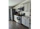 Modern kitchen with stainless steel appliances, grey cabinets, and white subway tile backsplash at 85 Heather Point Ct # 850, New Smyrna Beach, FL 32169
