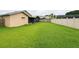 Spacious backyard with lush green grass, fenced perimeter, and screened-in porch at 1510 Avleigh Cir, Orlando, FL 32824