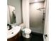 Modern bathroom features black fixtures, tiled shower, vanity, toilet, and a large mirror at 1510 Avleigh Cir, Orlando, FL 32824