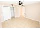 Neutral bedroom featuring tile flooring, a ceiling fan, and closet space at 1510 Avleigh Cir, Orlando, FL 32824