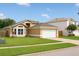 Charming single-story home featuring a well-manicured lawn and a two-car garage at 1510 Avleigh Cir, Orlando, FL 32824