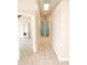 Bright hallway with tile flooring that leads to a bedroom and a double-door closet at 1510 Avleigh Cir, Orlando, FL 32824