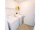 Laundry room with white washer and dryer, overhead shelf, and tile flooring at 1510 Avleigh Cir, Orlando, FL 32824
