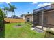 Well-maintained backyard with a screened-in patio and a wooden privacy fence at 433 Woodcrest St, Winter Springs, FL 32708