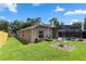 Backyard view featuring a pool with a screened-in enclosure and well-kept lawn at 433 Woodcrest St, Winter Springs, FL 32708