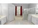 Bright bathroom featuring a large soaking tub, glass-enclosed shower, and double vanity sinks at 433 Woodcrest St, Winter Springs, FL 32708