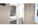 Bathroom with a vanity with a large mirror and vanity lighting, and a white paneled door to the right at 433 Woodcrest St, Winter Springs, FL 32708