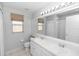 Bathroom with double sinks, a window, and a shower at 433 Woodcrest St, Winter Springs, FL 32708
