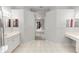 Spacious bathroom with double vanities and sinks, tile flooring, and an arched entry at 433 Woodcrest St, Winter Springs, FL 32708