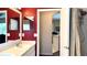 Bathroom with red walls, double vanity, framed mirrors and doorway to separate shower area at 433 Woodcrest St, Winter Springs, FL 32708