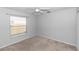 A gray bedroom with carpet, a window, and a ceiling fan at 433 Woodcrest St, Winter Springs, FL 32708
