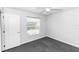 A small gray bedroom with a ceiling fan, window, and door at 433 Woodcrest St, Winter Springs, FL 32708