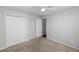 Gray bedroom with white closet doors and a ceiling fan at 433 Woodcrest St, Winter Springs, FL 32708
