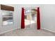 Bedroom view out to the screened pool area through a sliding glass door with red privacy curtains at 433 Woodcrest St, Winter Springs, FL 32708