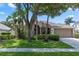 Well-maintained home featuring a manicured front yard, mature trees, and a welcoming facade at 433 Woodcrest St, Winter Springs, FL 32708