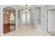 Bright foyer features a chandelier, double entry doors, arched doorway, and built-in shelf at 433 Woodcrest St, Winter Springs, FL 32708