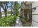 Beautifully landscaped walkway leads to the front entrance of this charming home with mature trees and flowering shrubs at 433 Woodcrest St, Winter Springs, FL 32708