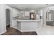 Bright kitchen with white cabinets and a breakfast bar that overlooks the dining area at 433 Woodcrest St, Winter Springs, FL 32708