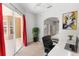 Bright home office features a sliding glass door, plant, and an arched opening to the bedroom at 433 Woodcrest St, Winter Springs, FL 32708