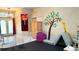Spacious playroom area with light-colored flooring, fun wall decals, and a gate at 433 Woodcrest St, Winter Springs, FL 32708