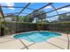 Backyard oasis featuring a gorgeous pool and spa within a screened enclosure and meticulously maintained landscaping at 433 Woodcrest St, Winter Springs, FL 32708
