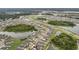 Wide aerial shot of a community featuring homes along the ponds and natural green spaces and a roadway at 5660 Keaton Springs Dr, Lakeland, FL 33811