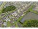Scenic aerial view of a residential community featuring multiple ponds and well-spaced homes with manicured lawns at 5660 Keaton Springs Dr, Lakeland, FL 33811