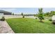 Spacious backyard with green grass, white fence, and a tranquil water view, ideal for outdoor activities at 5660 Keaton Springs Dr, Lakeland, FL 33811