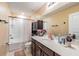 Bathroom with a well-lit vanity, sink, mirror, toilet, and a shower with curtain at 5660 Keaton Springs Dr, Lakeland, FL 33811