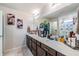 Bright bathroom featuring a spacious vanity with double sinks and a well-lit mirror at 5660 Keaton Springs Dr, Lakeland, FL 33811