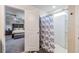 Bathroom with a view into the main bedroom, with a walk-in shower and floral curtain at 5660 Keaton Springs Dr, Lakeland, FL 33811