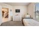 Comfortable bedroom with neutral walls, carpet, window, dresser and television at 5660 Keaton Springs Dr, Lakeland, FL 33811