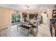 Bright dining area features stainless steel appliances, tiled floors and sliding glass doors to outdoors at 5660 Keaton Springs Dr, Lakeland, FL 33811