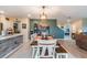 Open-concept dining area with wood table and chairs, and access to the kitchen and living room at 5660 Keaton Springs Dr, Lakeland, FL 33811