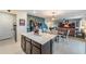Open kitchen features stainless steel appliances, stone countertops and center island with space for stools at 5660 Keaton Springs Dr, Lakeland, FL 33811