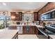 Bright kitchen with stainless steel appliances, tile backsplash, and white countertops at 5660 Keaton Springs Dr, Lakeland, FL 33811