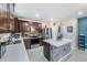 Modern kitchen features stainless steel appliances, stone countertops and a central island at 5660 Keaton Springs Dr, Lakeland, FL 33811