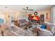 Spacious living room with tile floor, fireplace, TV, and multiple seating options at 5660 Keaton Springs Dr, Lakeland, FL 33811