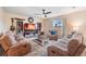 Comfortable living room featuring a fireplace, TV, ceiling fan, and plush seating at 5660 Keaton Springs Dr, Lakeland, FL 33811
