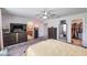 Spacious main bedroom with furniture set and view of the main bath and walk-in closet at 5660 Keaton Springs Dr, Lakeland, FL 33811