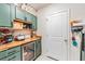 Well-organized pantry with counter, refrigerator and cabinets for ample storage at 5660 Keaton Springs Dr, Lakeland, FL 33811