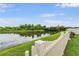 Scenic pond view with lush greenery and a white picket fence, offering a serene and peaceful setting at 5660 Keaton Springs Dr, Lakeland, FL 33811