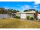 Spacious backyard with grass, a shed, and a covered parking area at 6143 Black Walnut Dr, Bartow, FL 33830