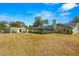 Expansive backyard view with a shed, large pool, and lush landscaping at 6143 Black Walnut Dr, Bartow, FL 33830