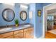 Stylish bathroom with dual sinks, wood cabinets, and modern lighting at 6143 Black Walnut Dr, Bartow, FL 33830