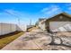 Long concrete driveway leading to a two-car garage with a well-maintained lawn and privacy fence at 6143 Black Walnut Dr, Bartow, FL 33830