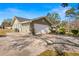 Spacious two-car garage featuring a wide driveway and side entry is located on a tree shaded lot at 6143 Black Walnut Dr, Bartow, FL 33830